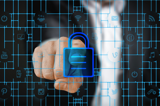 Close-up of a person's finger touching a glowing blue digital padlock icon overlaying a grid of social media and connectivity symbols, representing data privacy and secure user authentication.